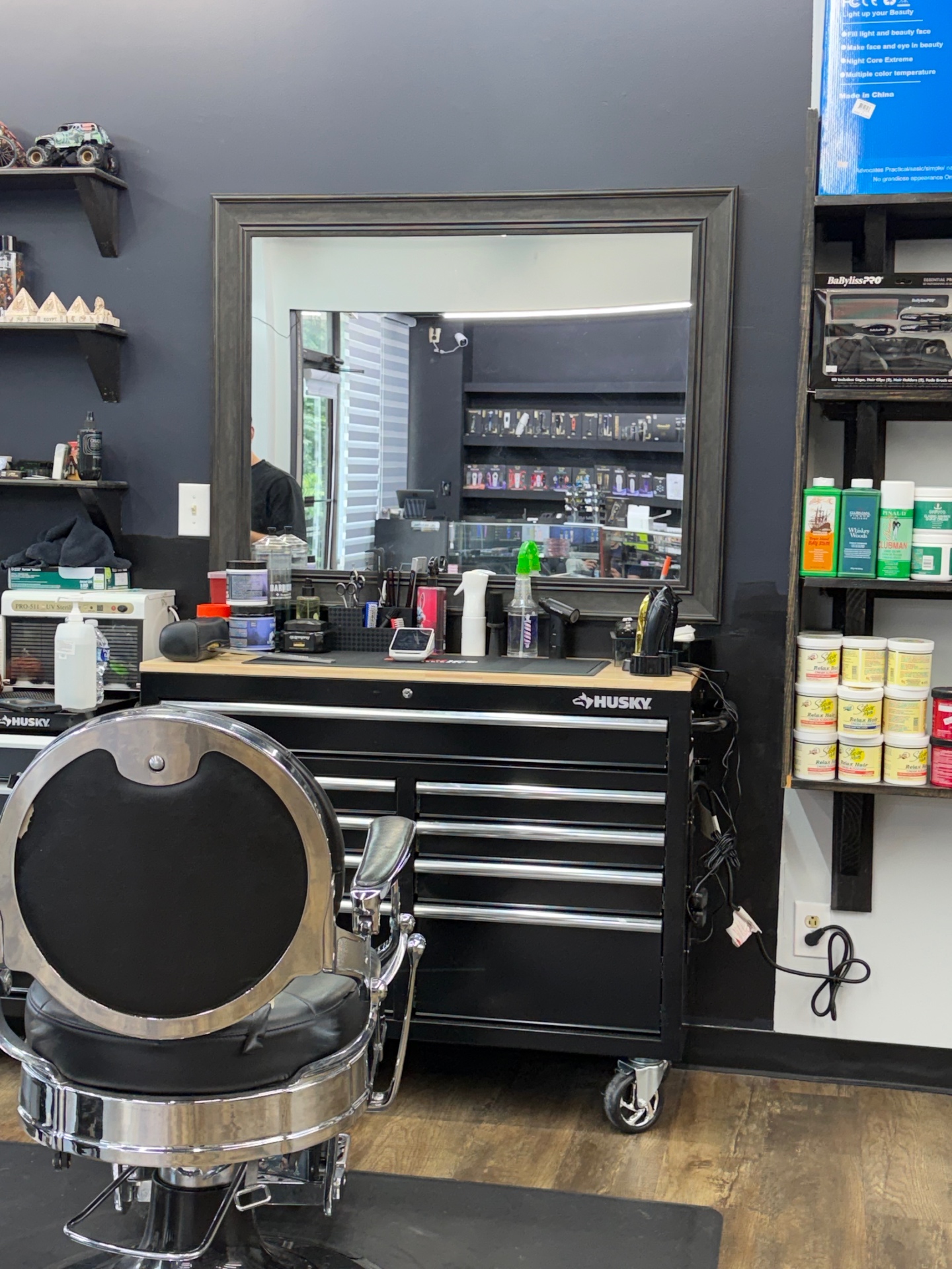 Barber station at Ivan's Barbershop with mirror, tools, and classic chair