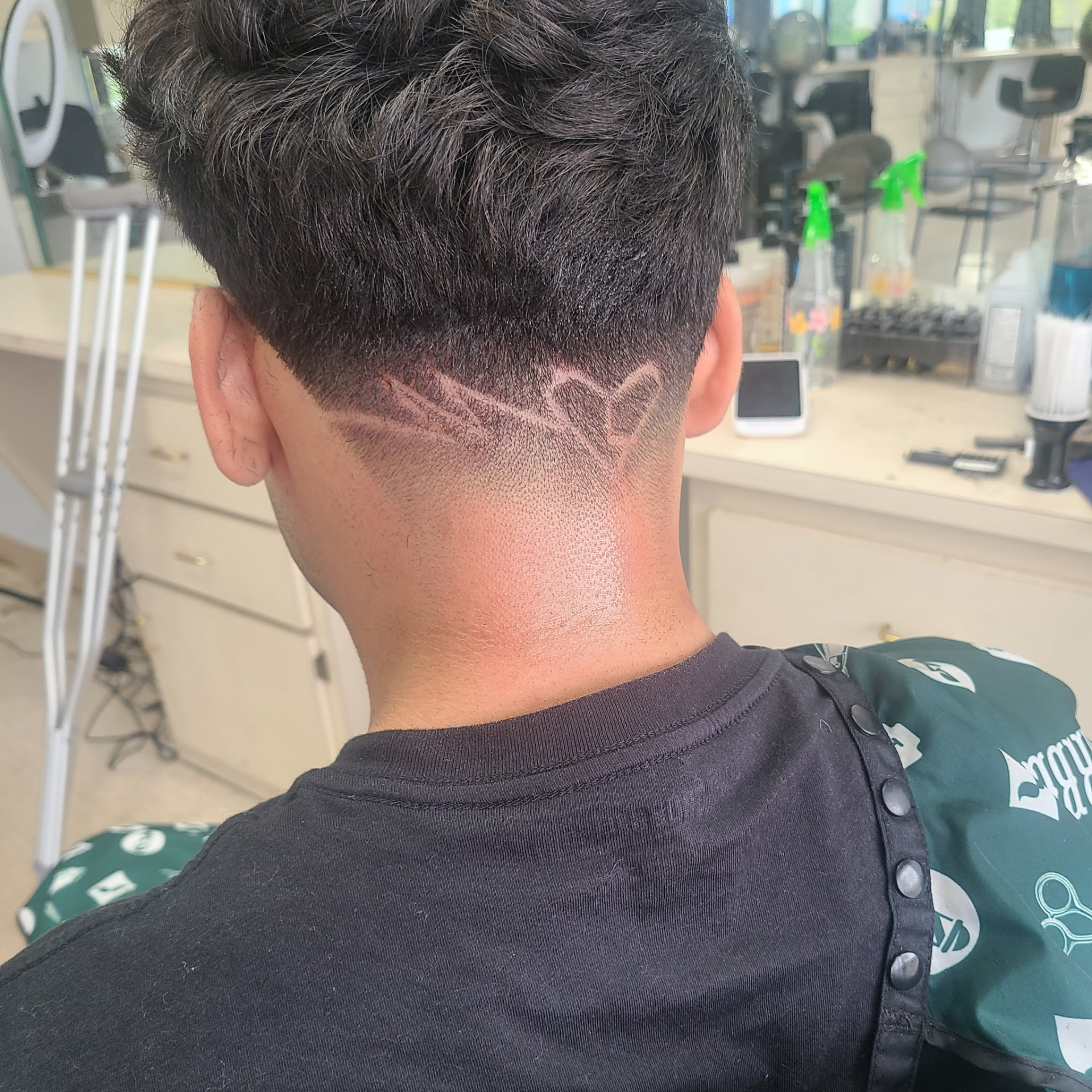 Custom design cut into a clean tapered neckline at Ivan's Barbershop