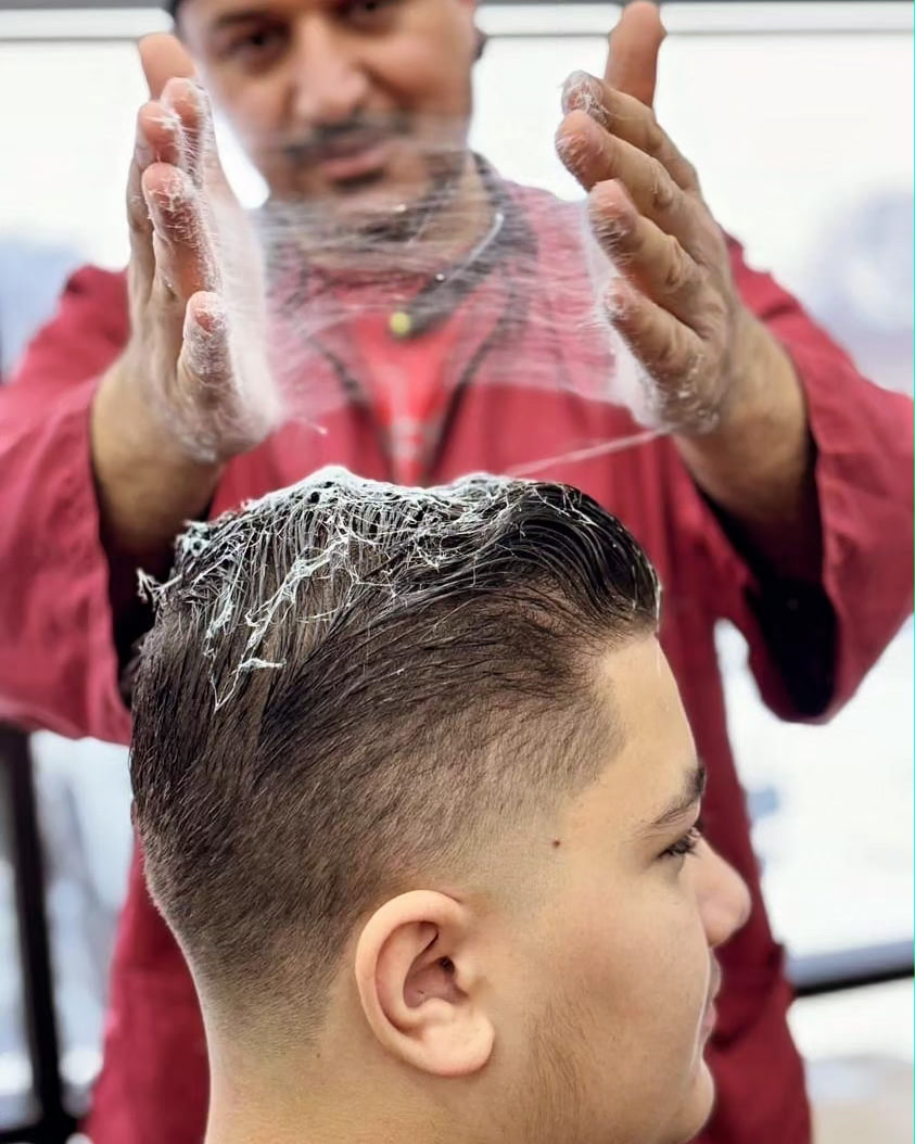 Ivan styling a fresh haircut with finishing product